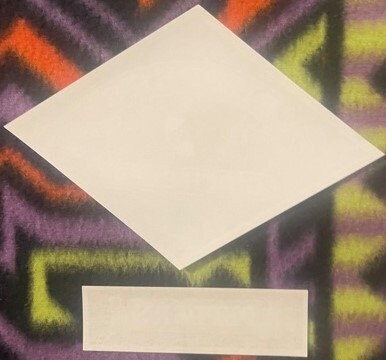 Two blank cream-colored rectangular paper samples displayed at angles against a colorful graffiti background for scale