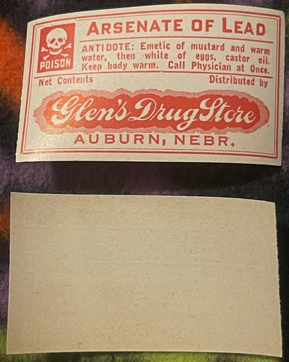 Vintage red and cream poison label for Arsenate of Lead from Glen's Drug Store, Auburn Nebraska, featuring skull and crossbon