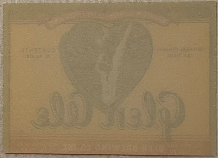 Reverse side of vintage Glen Ale beer label showing faint embossed eagle design on tan paper background