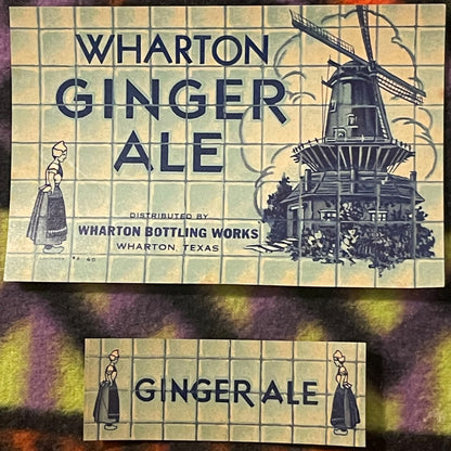 Two vintage Wharton Ginger Ale labels from Texas featuring Dutch girl illustrations and a windmill, cream-colored with blue t