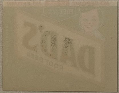 Vintage soda label showing partial Dad's Root Beer branding and text on cream-colored paper, photographed flat