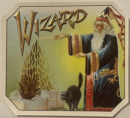Antique gold-embossed cigar box label featuring a wizard in blue robes pointing a wand at flames and a black cat, with ornate