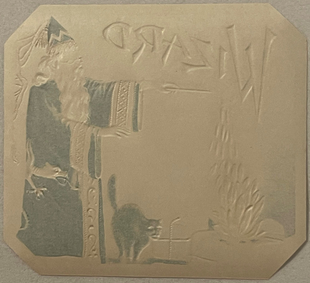 Gold embossed cigar box label featuring a wizard figure on left, black cat below, and decorative text reading "WIZARD" at top