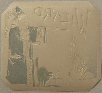 Gold embossed cigar box label featuring a wizard figure on left, black cat below, and decorative text reading "WIZARD" at top