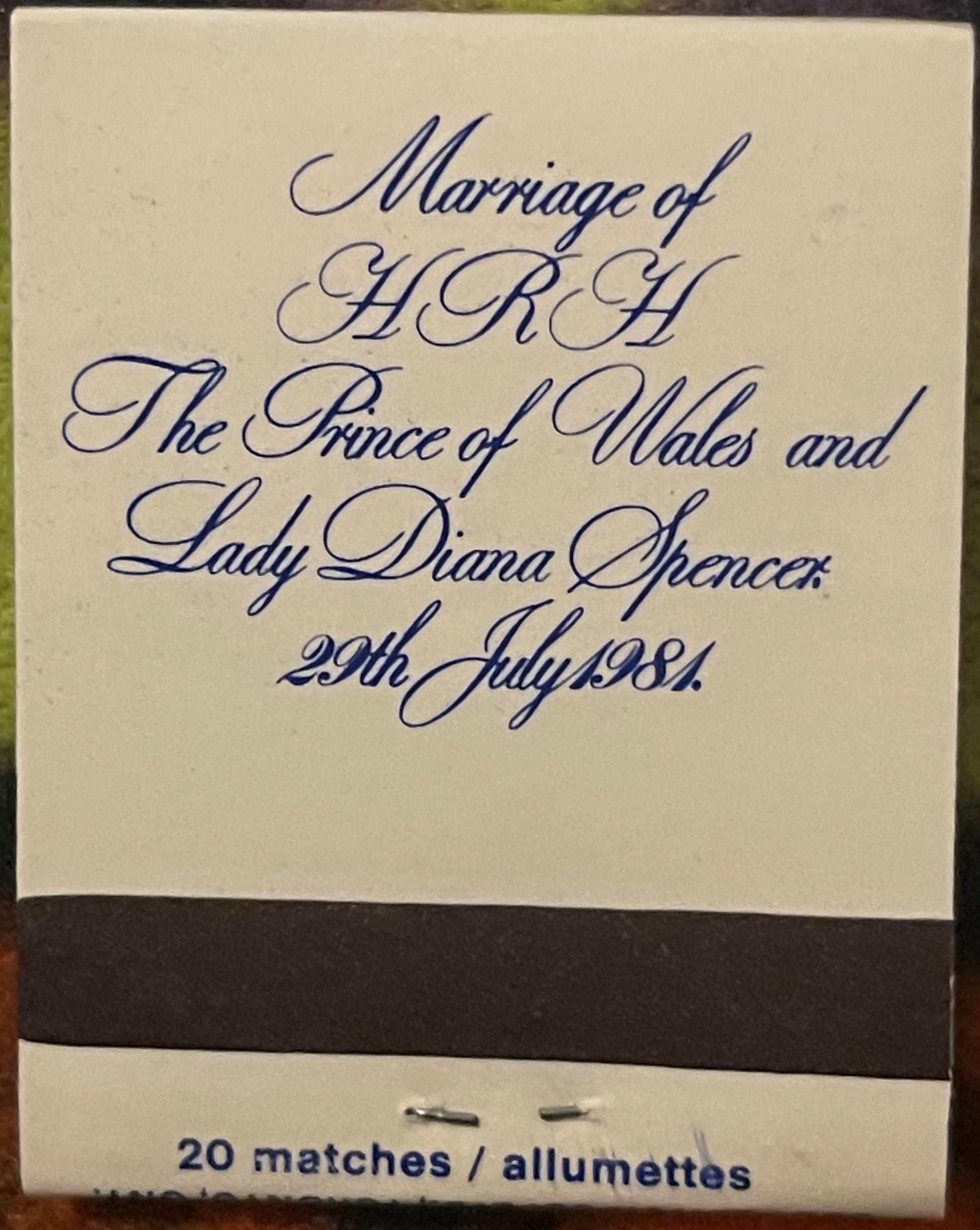 Cream-colored matchbook cover with blue cursive text reading "Marriage of HRH The Prince of Wales and Lady Diana Spencer 29th