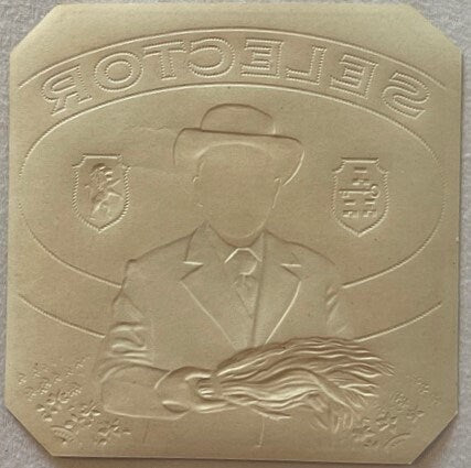 Embossed cream-colored rectangular plaque showing a man in a cowboy hat and mustache in profile, with "SOTOPELIE" text curved