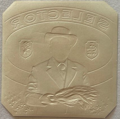 Embossed cream-colored rectangular plaque showing a man in a cowboy hat and mustache in profile, with "SOTOPELIE" text curved