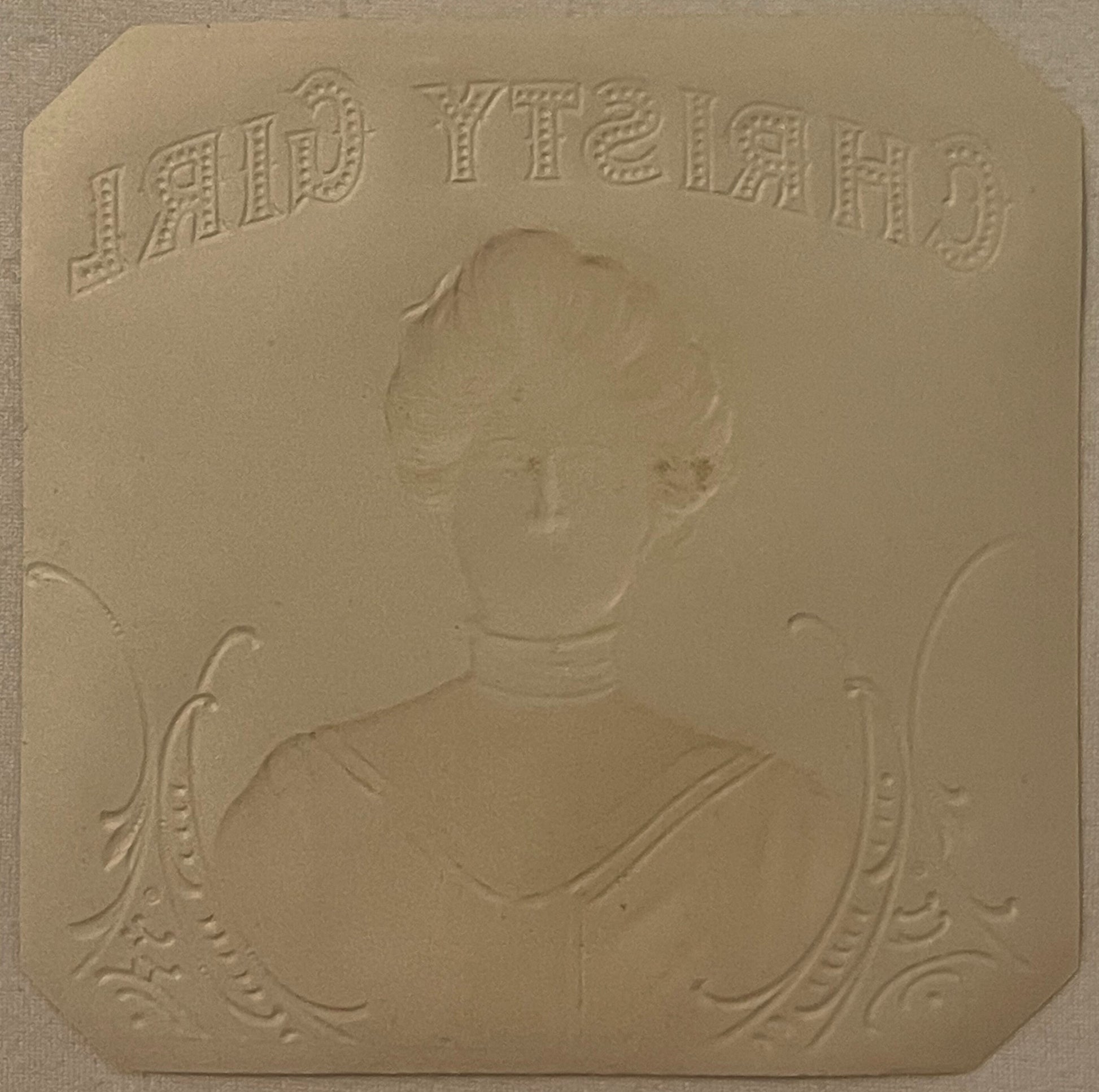 Embossed tan cardstock with "LADY TIEIRGH" text at top and portrait bust of woman in Victorian dress with decorative flourish