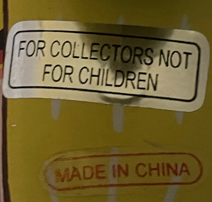 Macro of the mother duck's back: a paper sticker reading FOR COLLECTORS NOT FOR CHILDREN, with MADE IN CHINA embossed into the tin below it.