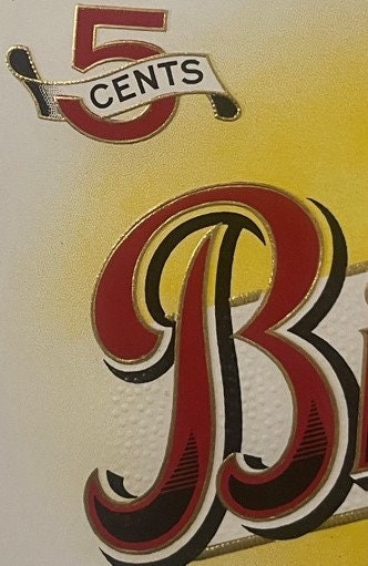 Antique cigar label with red "5 CENTS" banner at top and large ornate red "B" letter below on cream background