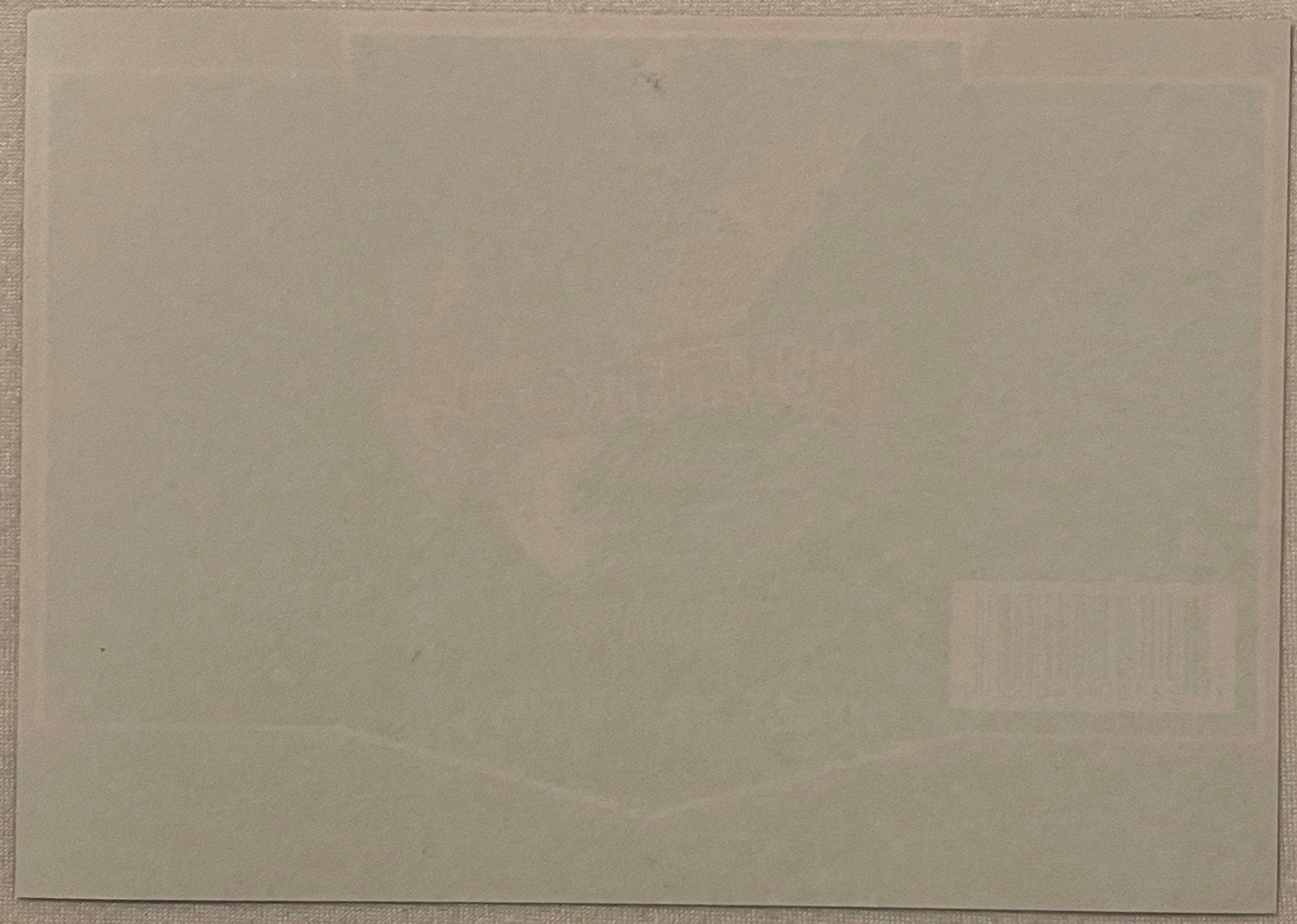 Blank cream-colored page or backing of vintage Odell Brewing beer label set against textured border