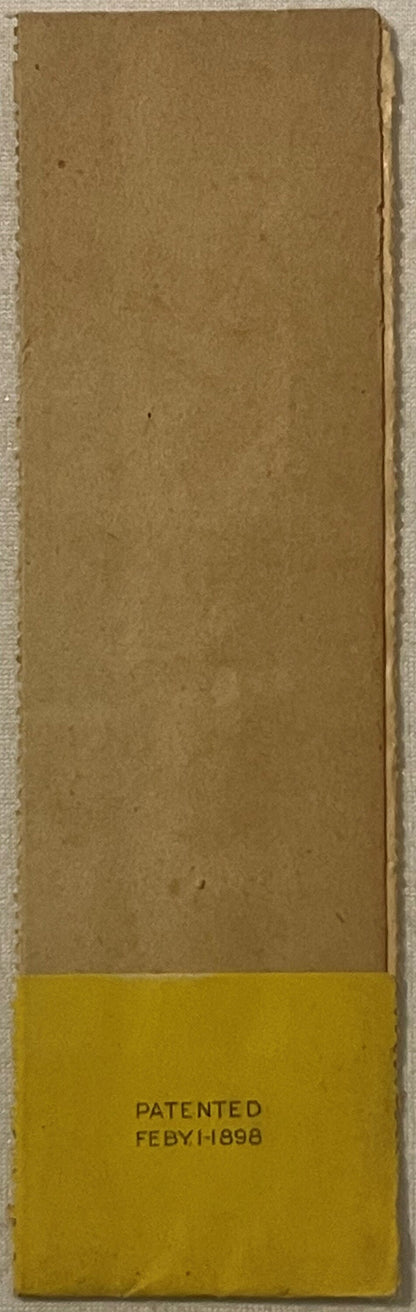 Tan kraft paper label with yellow bottom section printed "PATENTED FEBY.1-1898", displayed flat against light background