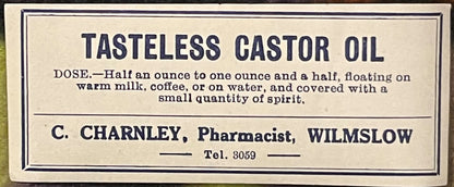 Cream-colored vintage pharmacy label with black text for Tasteless Castor Oil by C. Charnley, Pharmacist, Wilmslow