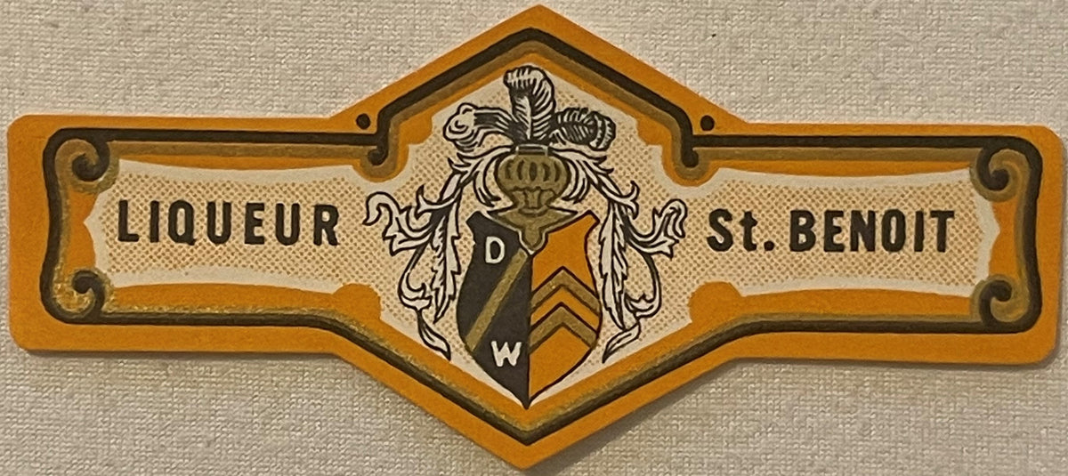 Vintage Liqueur St. Benoit bottle neck label with ornate orange and gold heraldic crest, scrollwork, and DW monogram on cream
