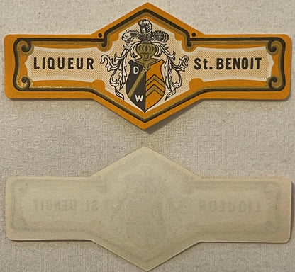 Vintage Liqueur St. Benoit bottle neck label with orange heraldic crest and blank cream-colored band below, displayed flat ag