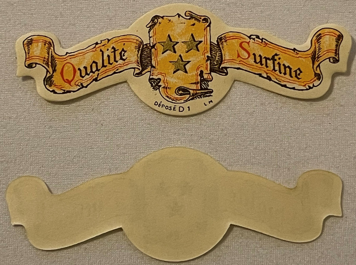 Vintage die-cut paper collar label with gold banners reading "Qualite" and "Surfine," three stars, and French text "DÉPOSÉ D 