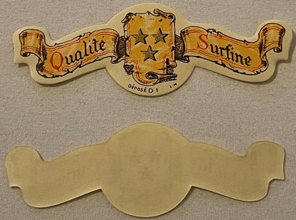 Vintage die-cut paper collar label with gold banners reading "Qualite" and "Surfine," three stars, and French text "DÉPOSÉ D 