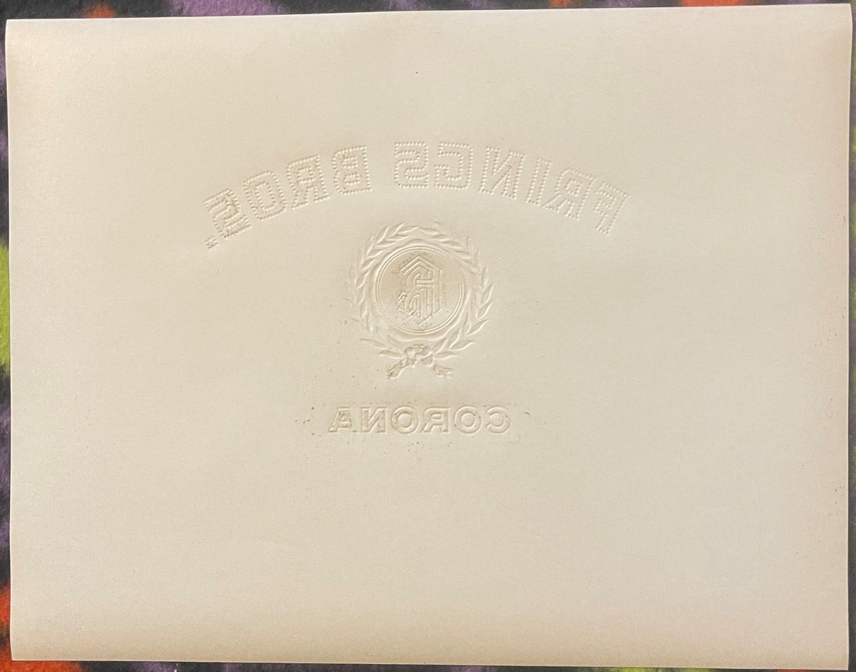 Back of the Frings Bros. Corona cigar label: plain cream paper with the embossed design pressed through in reverse, the arched FRINGS BROS. lettering, the laurel wreath and FB seal, and CORONA