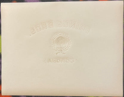Back of the Frings Bros. Corona cigar label: plain cream paper with the embossed design pressed through in reverse, the arched FRINGS BROS. lettering, the laurel wreath and FB seal, and CORONA