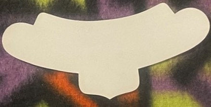 Blank cream-colored wine label with scalloped edges against a colorful textured background of purple, orange, and yellow tone
