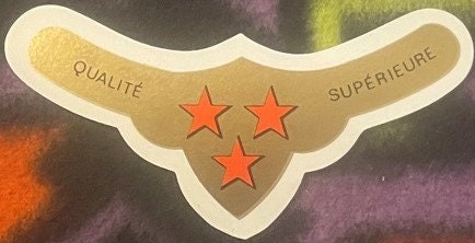 Vintage gold wine label with cream border, three red stars, and French text "Qualité" and "Supérieure