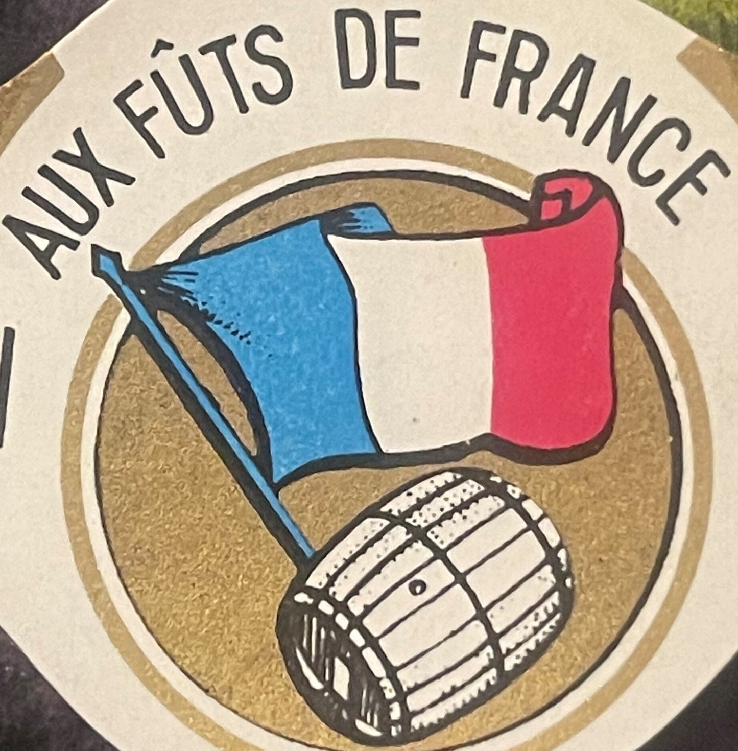 Vintage wine bottle neck label with French flag and fencing mask illustration, tan background with black text reading "AUX FÛ