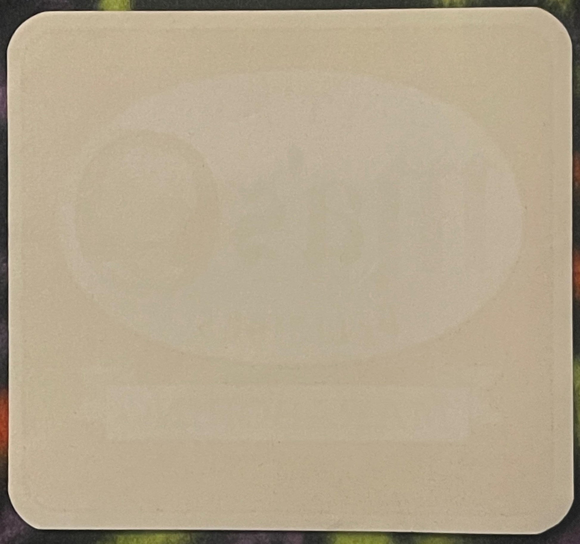 Blank cream-colored vintage soda label with rounded corners on dark textured background