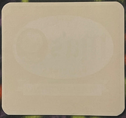 Blank cream-colored vintage soda label with rounded corners on dark textured background