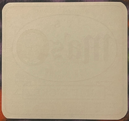 Blank cream-colored vintage soda bottle label with rounded corners on dark wooden surface