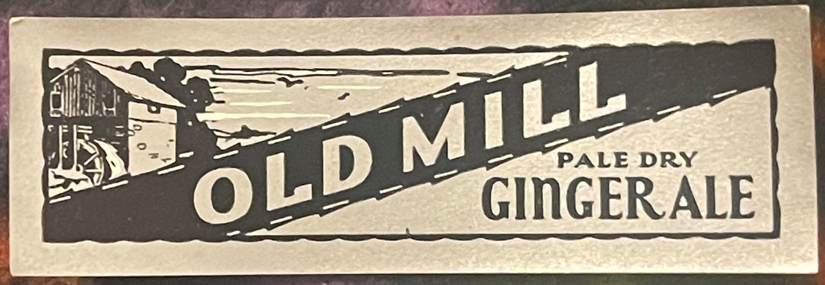 Vintage Old Mill Pale Dry Ginger Ale label with mill building illustration and bold diagonal text on cream background