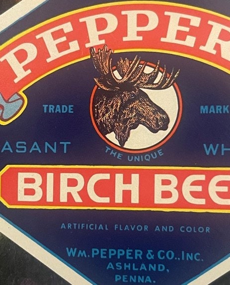 Vintage Pepper's Birch Beer bottle label with moose head illustration, red and navy blue design, Wm. Pepper & Co. Ashland PA 