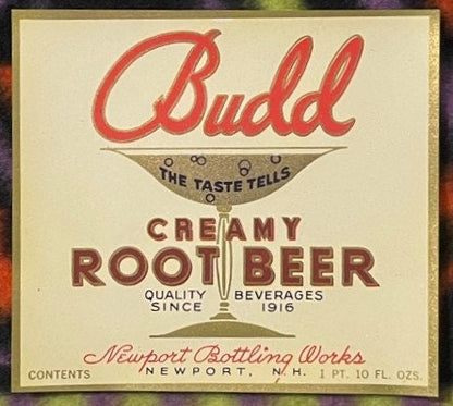 Vintage Budd Creamy Root Beer label with red script logo, cream background, and Newport Bottling Works text, 1 pint 10 fl oz 