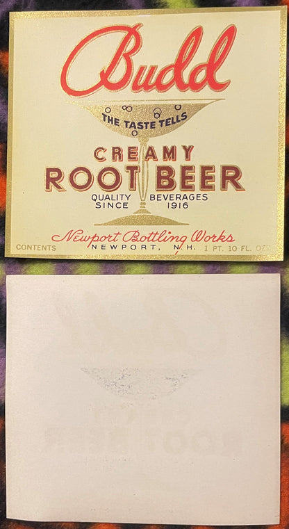 Vintage Budd Creamy Root Beer label with red script text, gold glitter border, and glass illustration, front and back shown