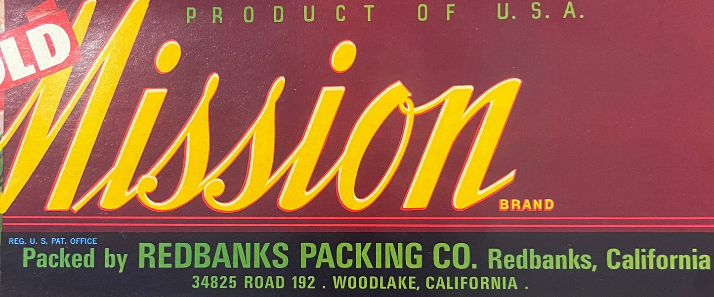 Vintage citrus crate label with yellow "Mission" brand text on maroon background, "Product of U.S.A." and Redbanks Packing Co