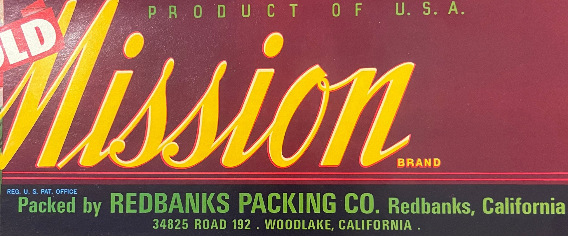 Vintage citrus crate label with yellow "Mission" brand text on maroon background, "Product of U.S.A." and Redbanks Packing Co