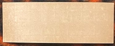 Blank tan-colored vintage label or paper with dark brown border, appears aged and weathered