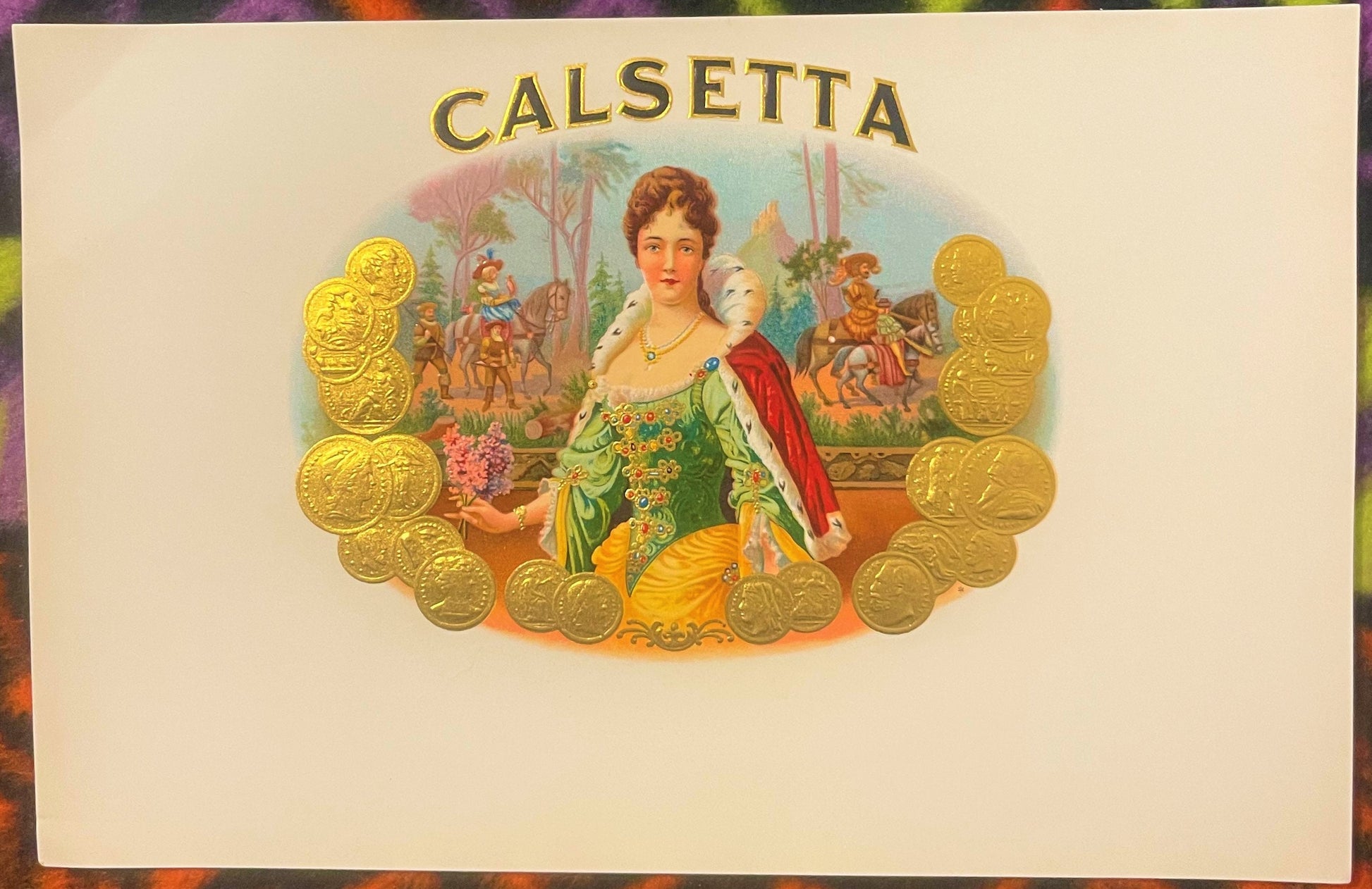 Antique Calsetta cigar label with gold embossed border of coins, featuring a regal woman in green dress with red cape against