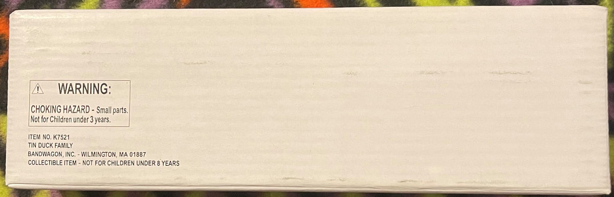 The back of the white Bandwagon box, its printed panel reading WARNING: CHOKING HAZARD, Small parts, Not for Children under 3 years, above ITEM NO. K7521, TIN DUCK FAMILY, BANDWAGON, INC. - WILMINGTON, MA 01887, and COLLECTIBLE ITEM - NOT FOR CHILDREN UND