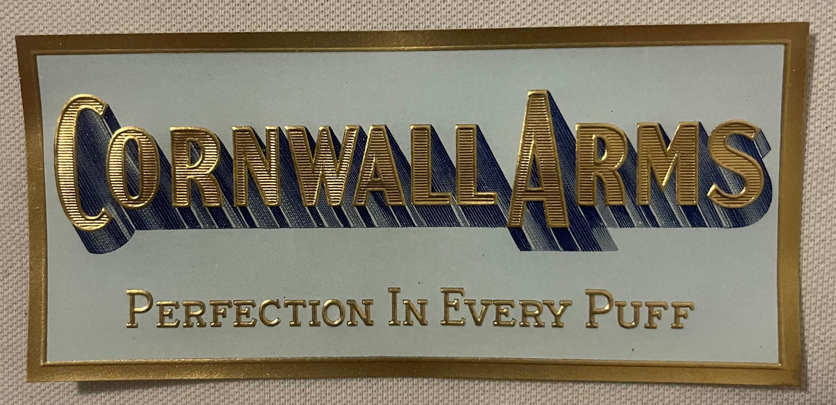 The small Cornwall Arms label: gold-embossed lettering with a blue cast shadow on a pale blue-gray ground, inside a printed gold border