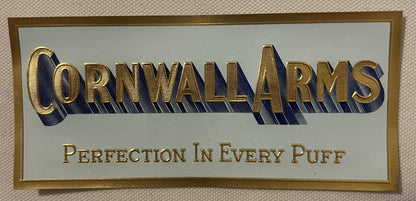 The small Cornwall Arms label: gold-embossed lettering with a blue cast shadow on a pale blue-gray ground, inside a printed gold border