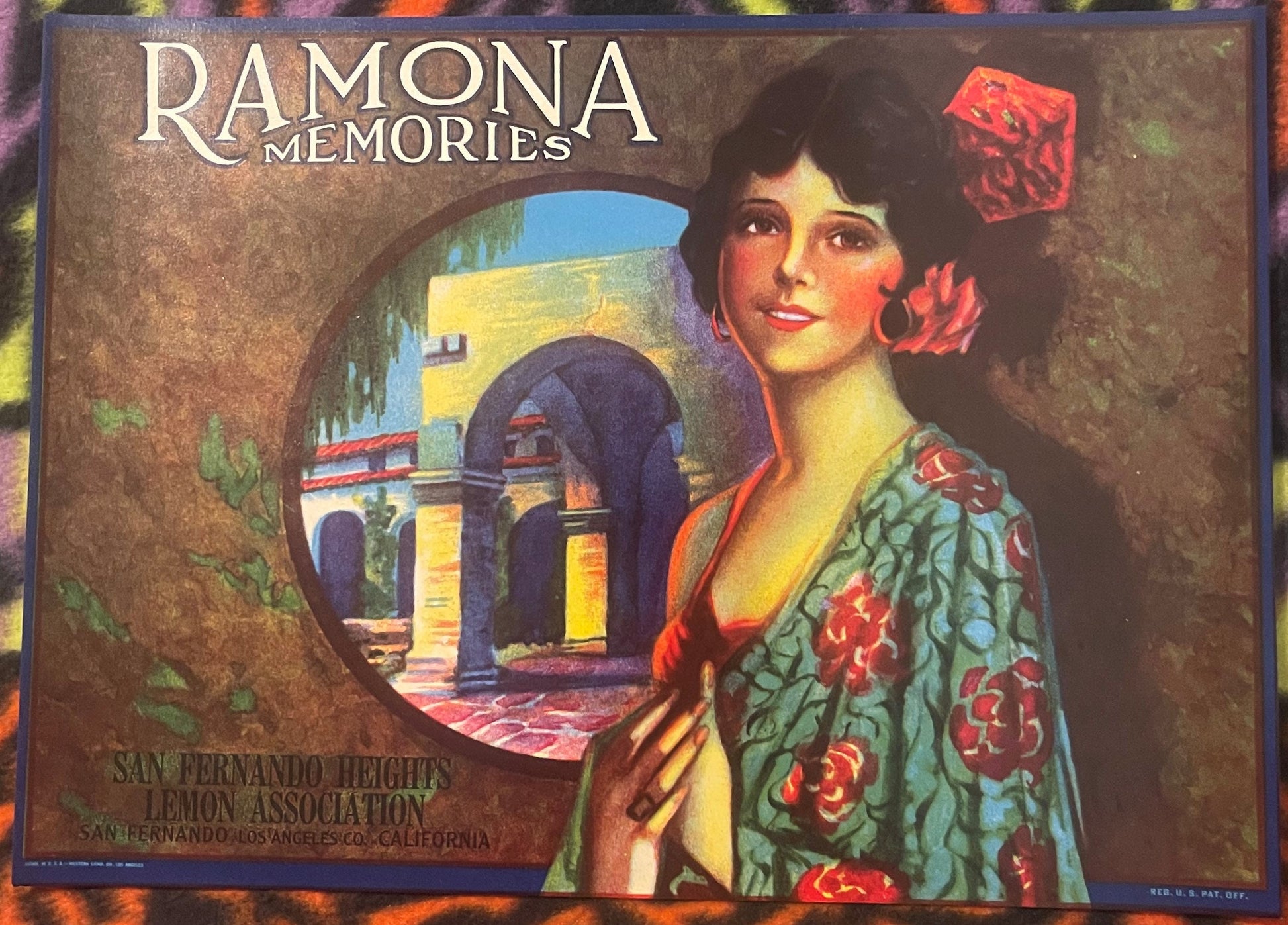 Vintage lemon crate label with Art Deco woman in embroidered robe, Mediterranean archway scene, and "Ramona Memories" text on