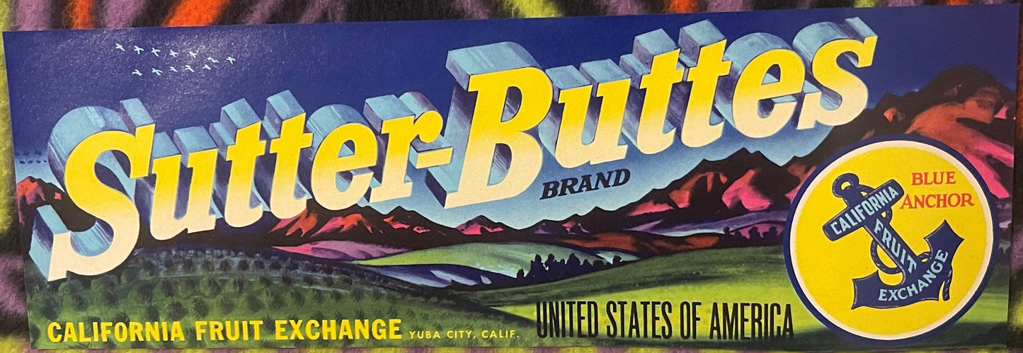 Vintage fruit crate label with "Sutter-Buttes" in large yellow letters, mountain landscape, California Fruit Exchange text, a