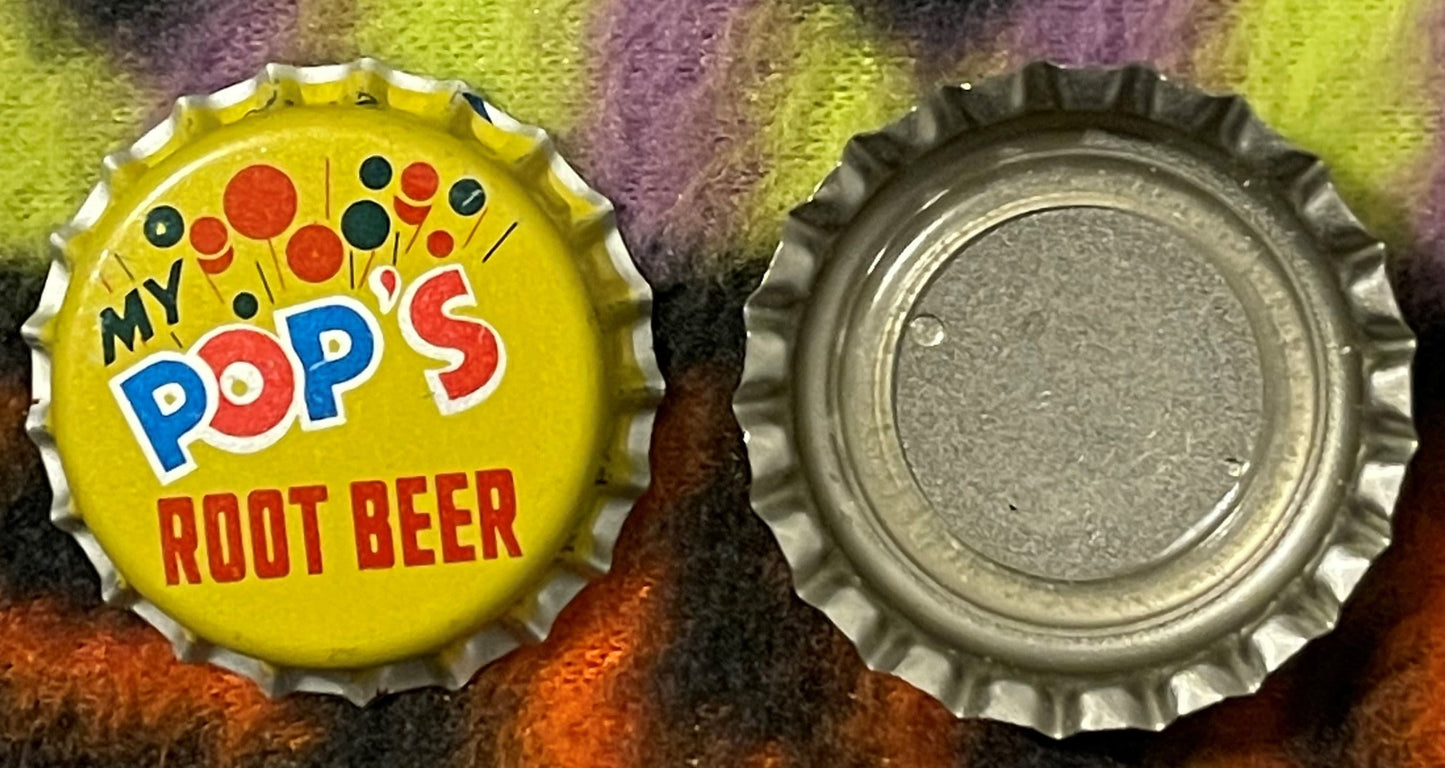 Vintage My Pop's Root Beer bottle cap showing yellow front with colorful dots and text, and metal reverse side, displayed on 