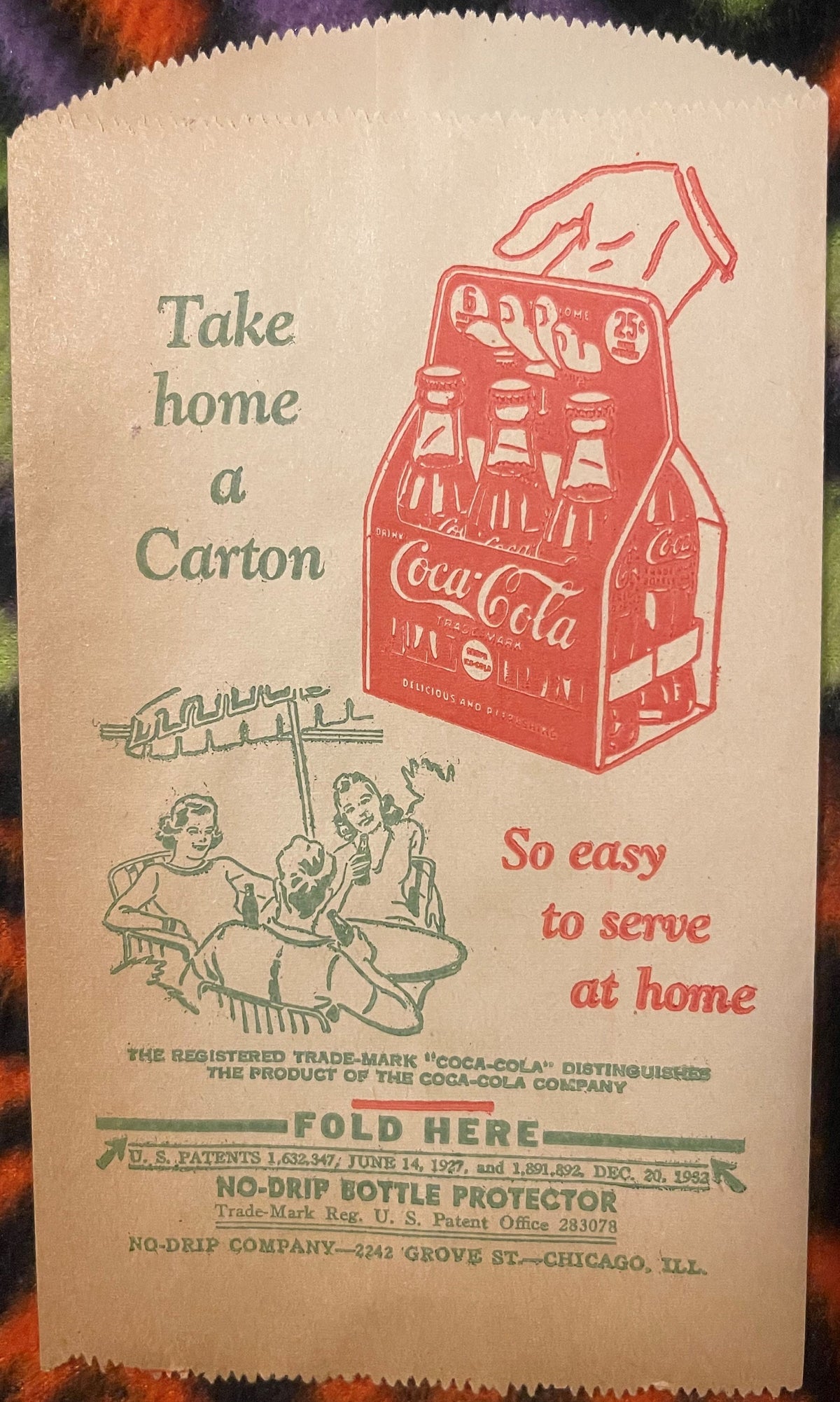Vintage Coca-Cola paper bottle protector sleeve from Chicago showing red carton illustration, green text, and couple