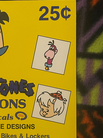 Yellow vintage vending sign showing 25¢ price with cartoon character illustrations and partial text mentioning Flintstones, J