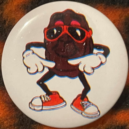 Single white pinback button featuring a cartoon character with dark body, red sunglasses, white gloved hands, red shoes, and 