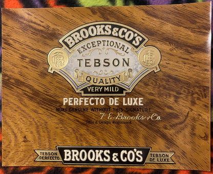 Antique cigar label with embossed gold and silver metallic design on woodgrain background reading "Brooks & Co's Exceptional 