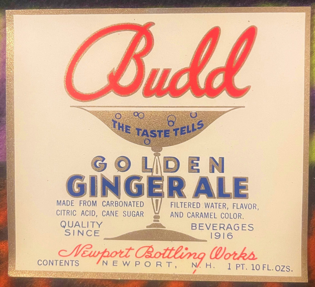 Vintage Budd Golden Ginger Ale label with red script text, gold goblet illustration, and blue text on cream background, Newpo
