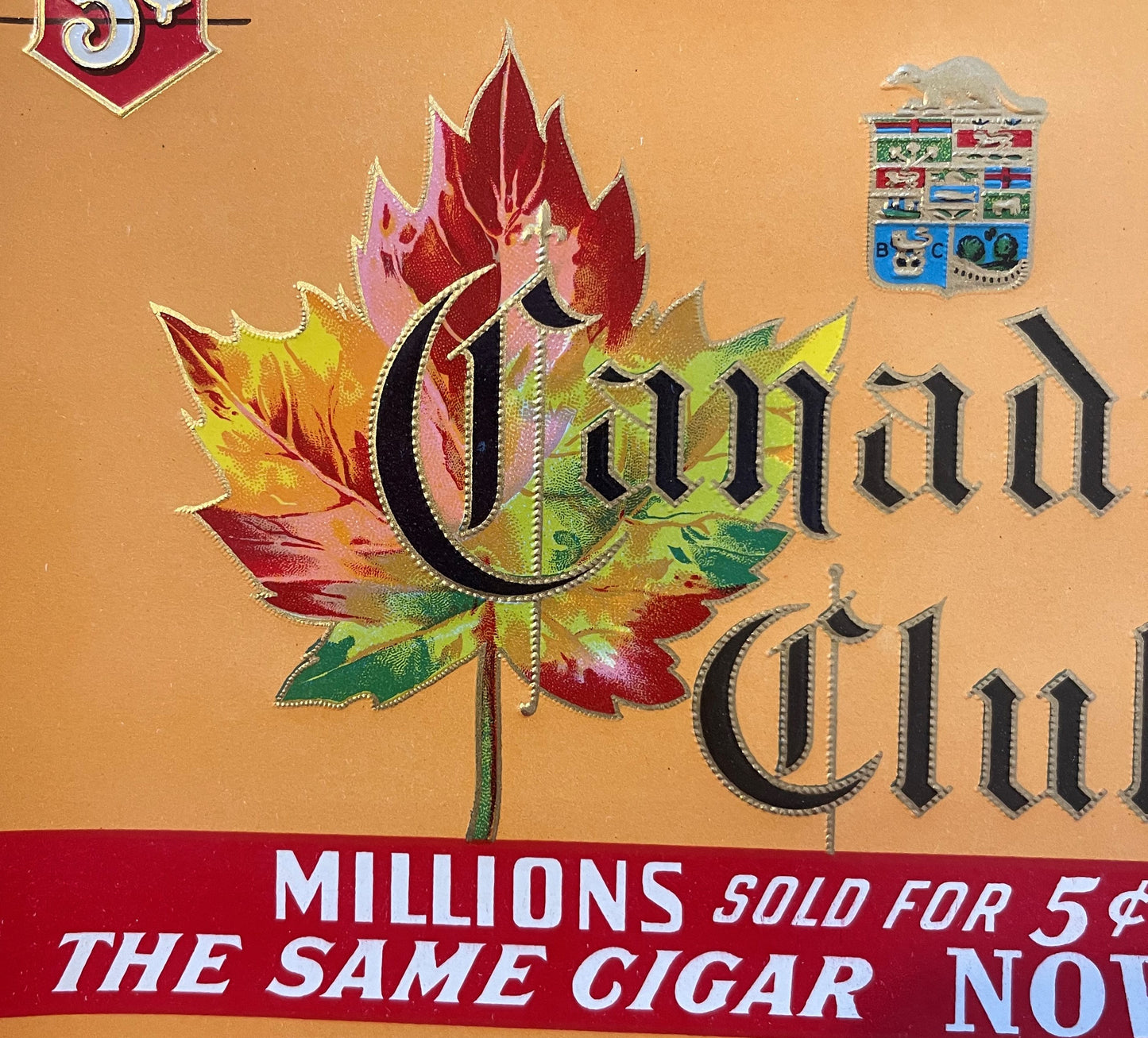 Vintage cigar label with ornate red and yellow maple leaf, black text reading "Ounun" and "Ounun", red banner stating "MILLIO