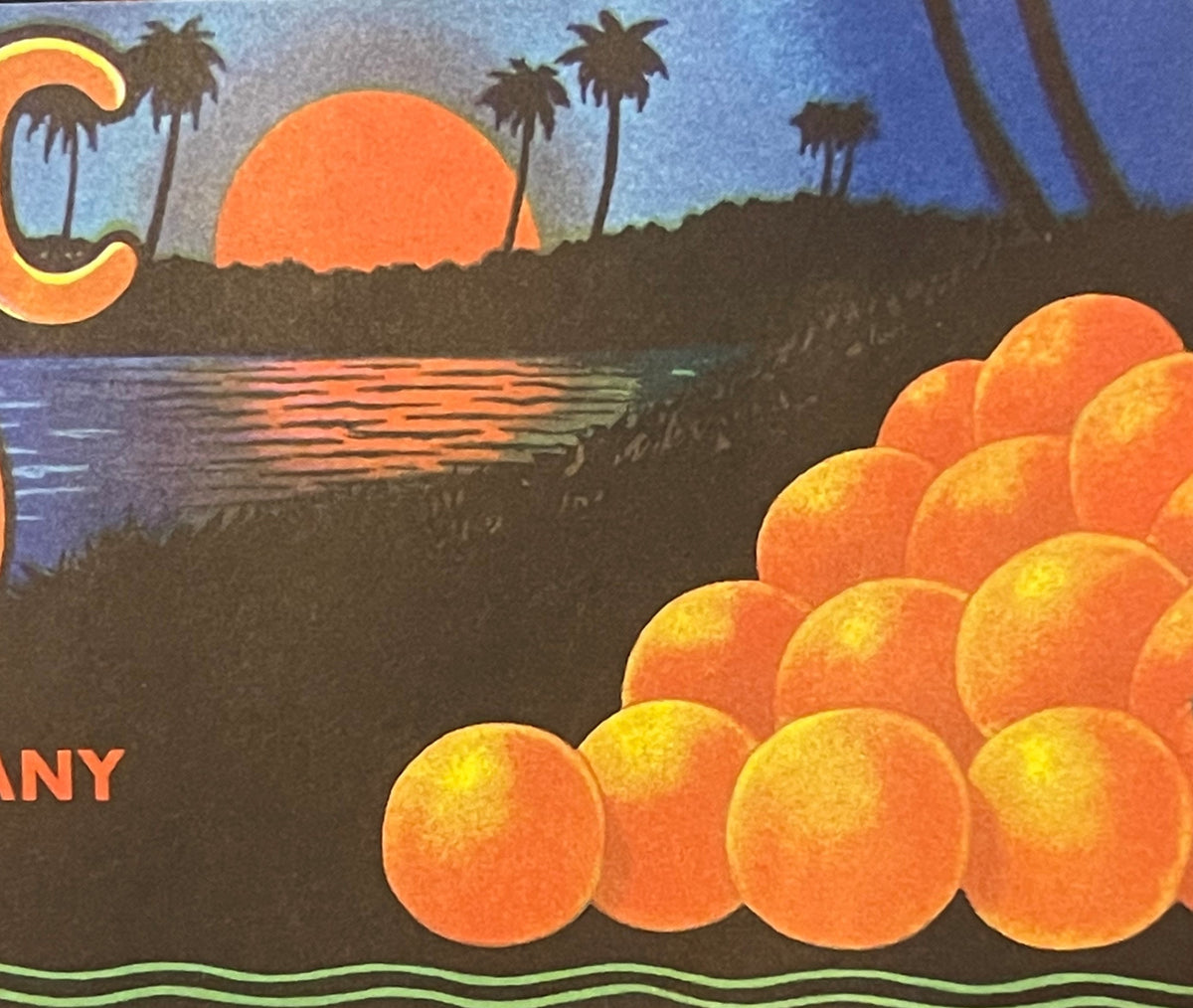 Antique citrus crate label featuring golden oranges in foreground, tropical sunset over palm trees and water, text reading "ANY" and "McBride Packing Company Seville Florida" visible on dark background.